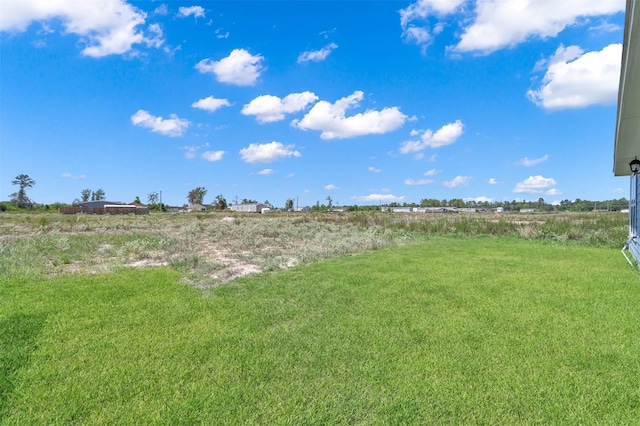 view of yard with a rural view