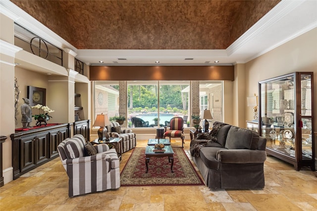 living room with ornamental molding and a high ceiling