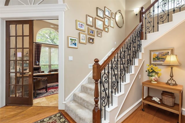 stairs with hardwood / wood-style flooring