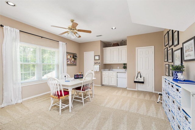 dining room with light carpet and ceiling fan