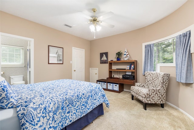 bedroom featuring carpet flooring, ensuite bathroom, and ceiling fan