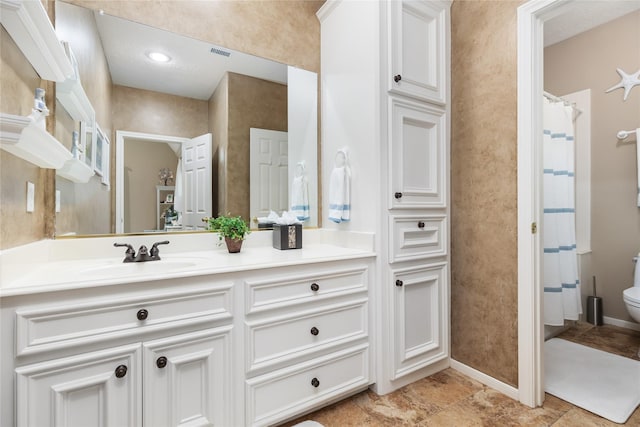 bathroom featuring vanity and toilet