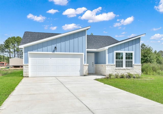 contemporary house with a front yard and a garage