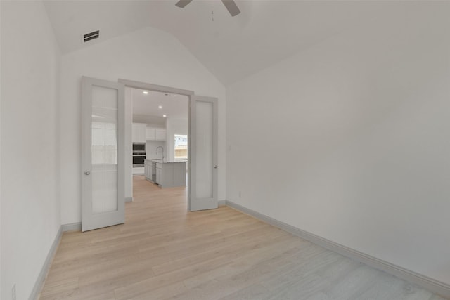 13318 Pine Lake Bnd, Tomball, TX 77375 - unfurnished room with french doors, light hardwood / wood-style floors, lofted ceiling, and sink