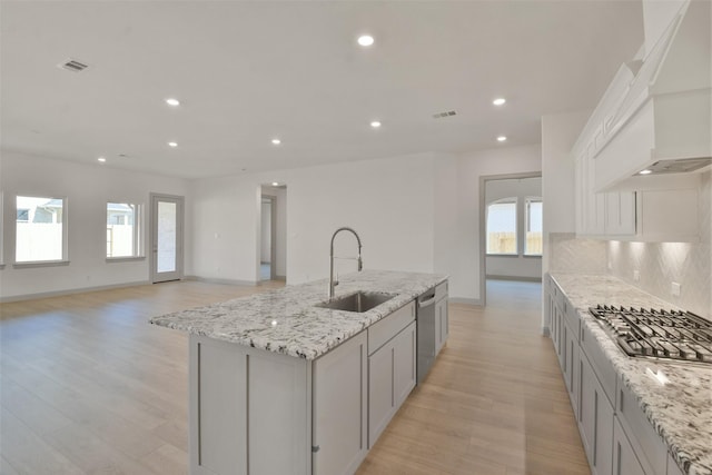 13318 Pine Lake Bnd, Tomball, TX 77375 - kitchen featuring a center island with sink, a healthy amount of sunlight, sink, and appliances with stainless steel finishes