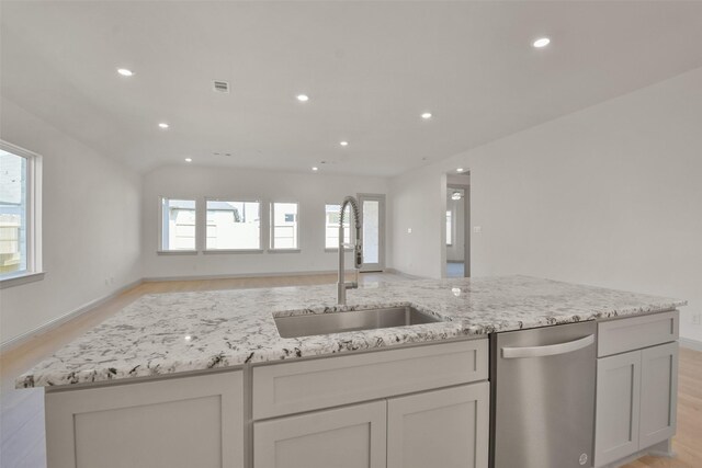 13318 Pine Lake Bnd, Tomball, TX 77375 - kitchen with dishwasher, sink, light hardwood / wood-style flooring, lofted ceiling, and white cabinets