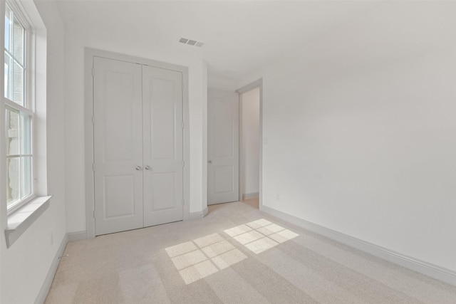 13318 Pine Lake Bnd, Tomball, TX 77375 - unfurnished bedroom featuring light carpet and a closet