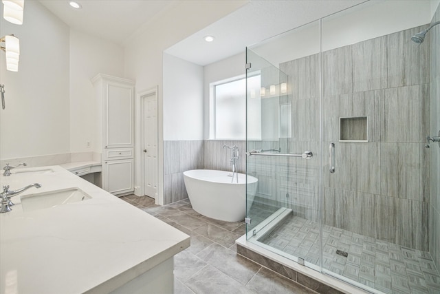 bathroom featuring vanity and independent shower and bath