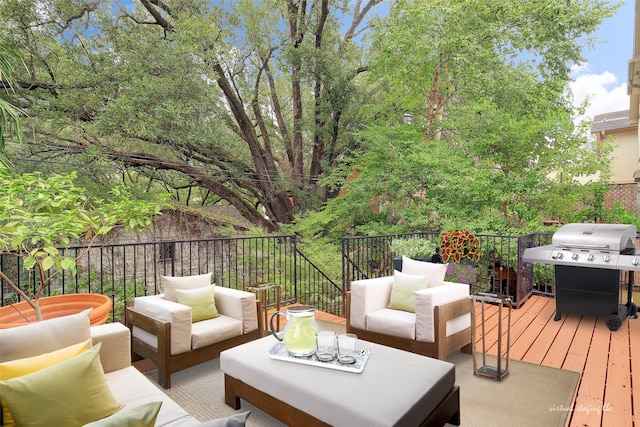 wooden deck featuring outdoor lounge area and a grill