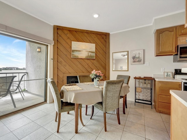 tiled dining room featuring crown molding