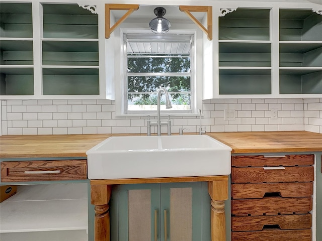 kitchen with sink, decorative backsplash, and wooden counters