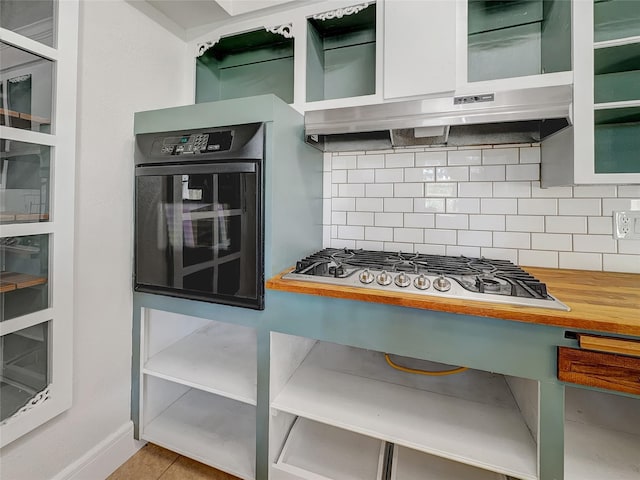 kitchen featuring stainless steel gas stovetop, oven, and decorative backsplash