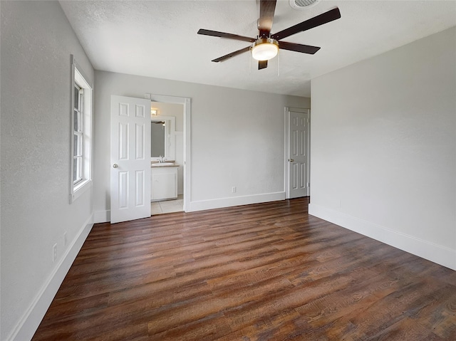 empty room featuring ceiling fan, dark hardwood / wood-style flooring, and sink