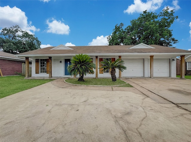 ranch-style house featuring a front lawn and a garage