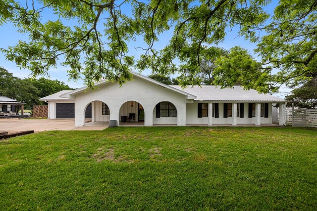 single story home featuring a garage and a front lawn