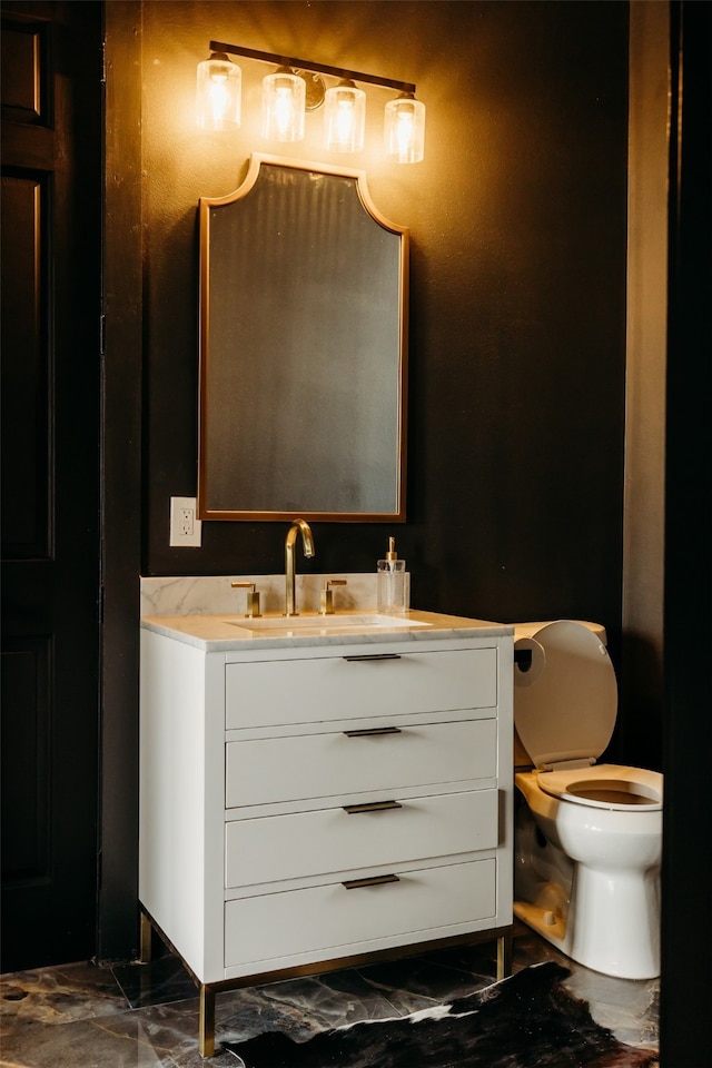 bathroom featuring tile floors, vanity with extensive cabinet space, and toilet