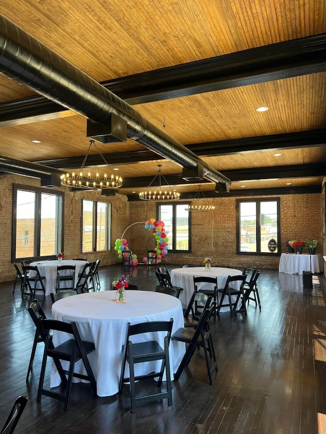 dining room featuring beamed ceiling, brick wall, wood ceiling, and dark wood-type flooring