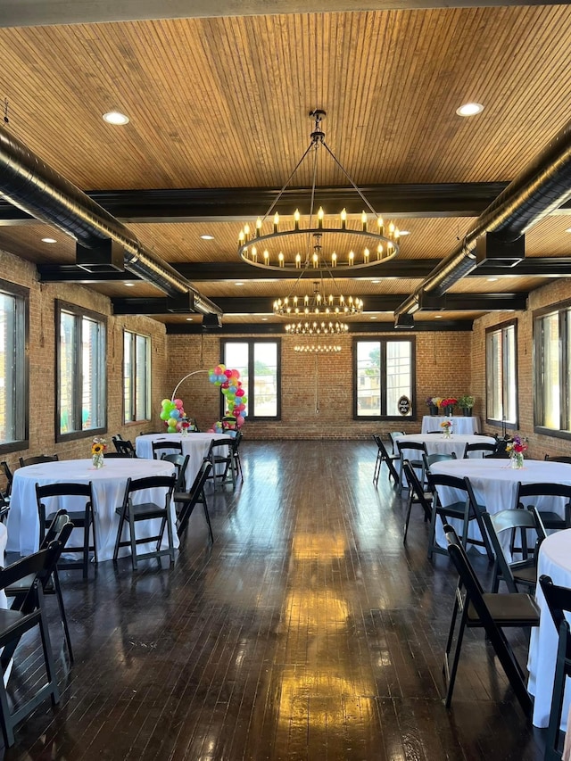 dining room featuring brick wall, an inviting chandelier, dark hardwood / wood-style floors, and wood ceiling