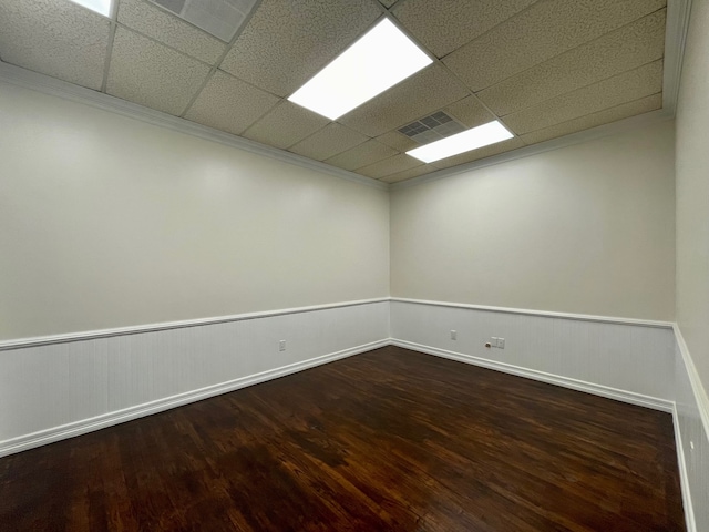 unfurnished room with wood-type flooring and a drop ceiling