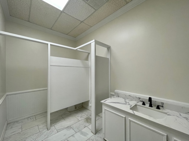 bathroom with tile floors, a paneled ceiling, vanity, and toilet