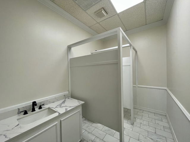 bathroom featuring tile flooring, vanity, and a drop ceiling