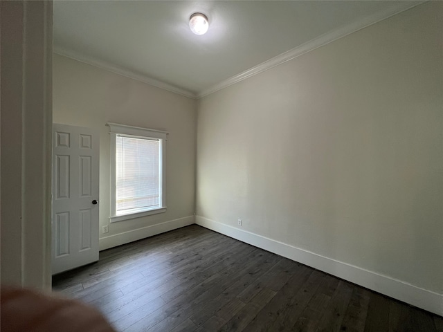 unfurnished room featuring crown molding and dark wood-type flooring