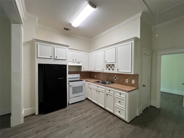 kitchen with wood-type flooring, white electric range, tasteful backsplash, black refrigerator, and sink