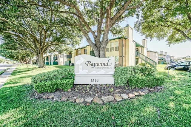 community / neighborhood sign with a lawn