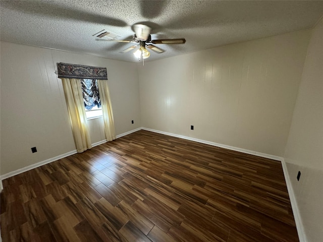 empty room featuring a textured ceiling, ceiling fan, and dark wood-type flooring