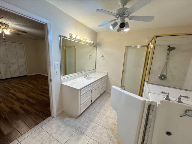 bathroom featuring ceiling fan, separate shower and tub, wood-type flooring, a textured ceiling, and vanity