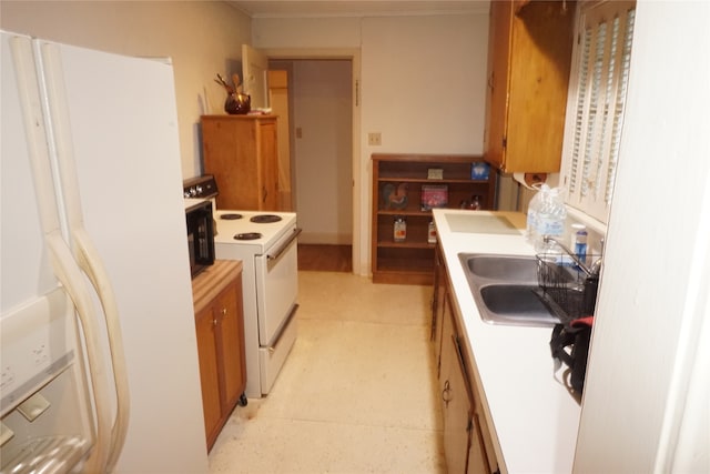 kitchen with white appliances, sink, and light tile flooring