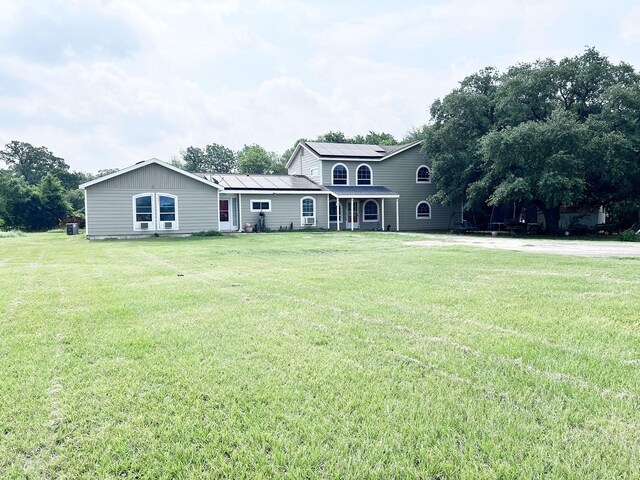 13074 Clover Ln, Iola, TX 77861 - view of front of house with a front lawn and solar panels