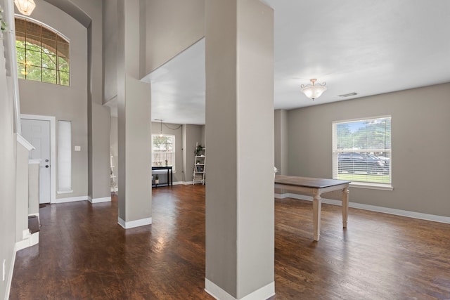 foyer with a chandelier and dark wood-type flooring