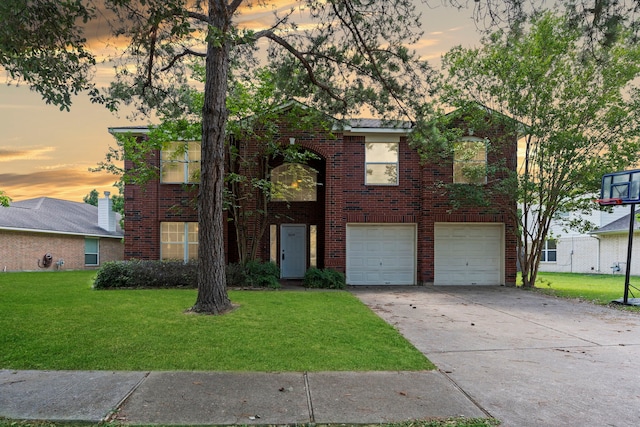 view of front of property with a yard and a garage