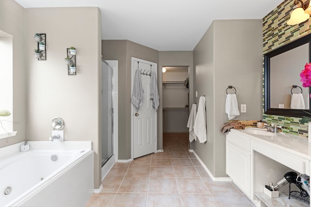 bathroom featuring tile patterned floors, vanity, separate shower and tub, and decorative backsplash