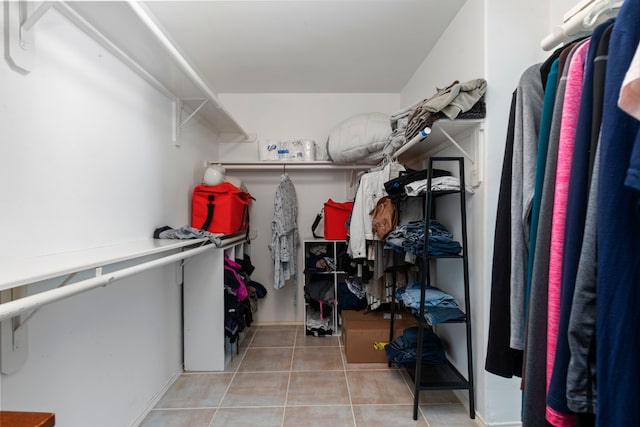 walk in closet featuring light tile patterned flooring