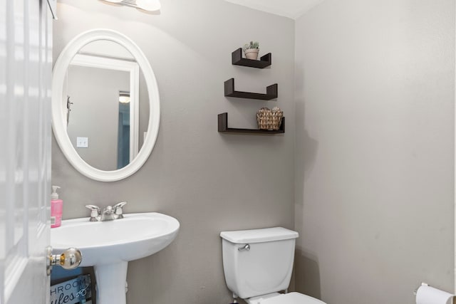 bathroom featuring toilet and sink