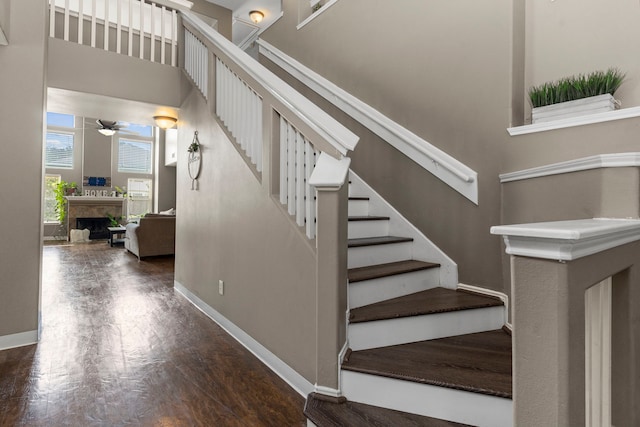 stairway featuring hardwood / wood-style floors and ceiling fan