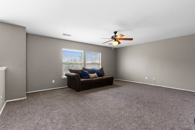 sitting room featuring ceiling fan and dark colored carpet