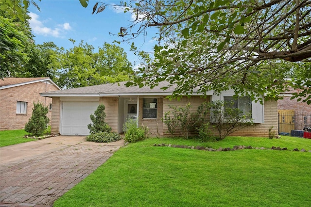 single story home with a front yard and a garage