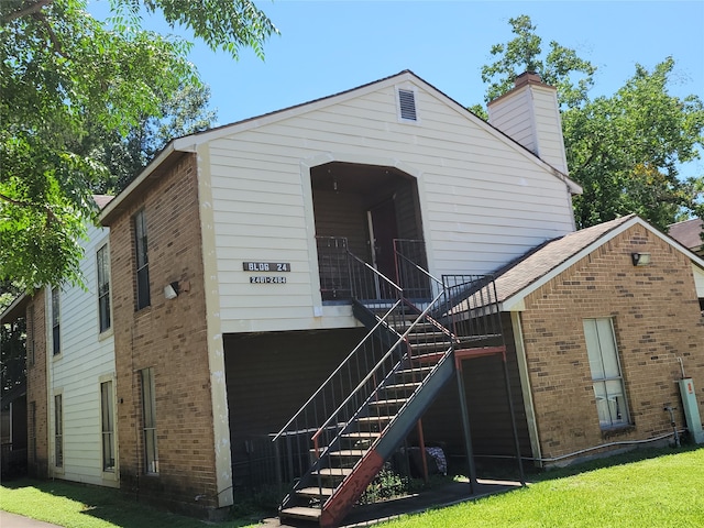 back of property featuring a lawn