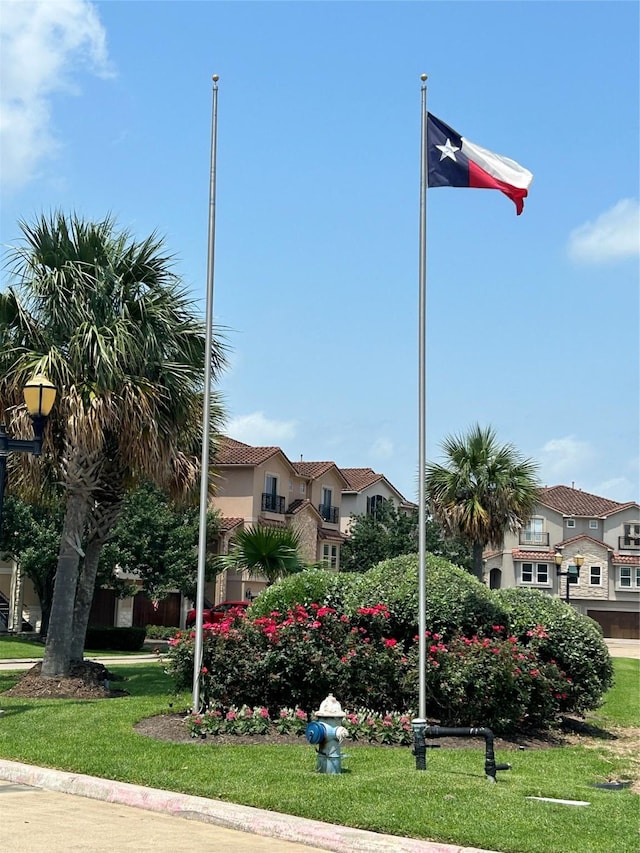 view of community featuring a residential view and a lawn