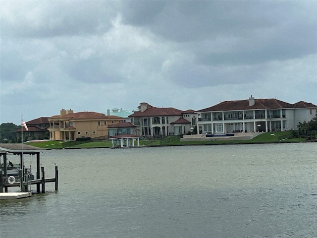 water view featuring a dock, a residential view, and boat lift