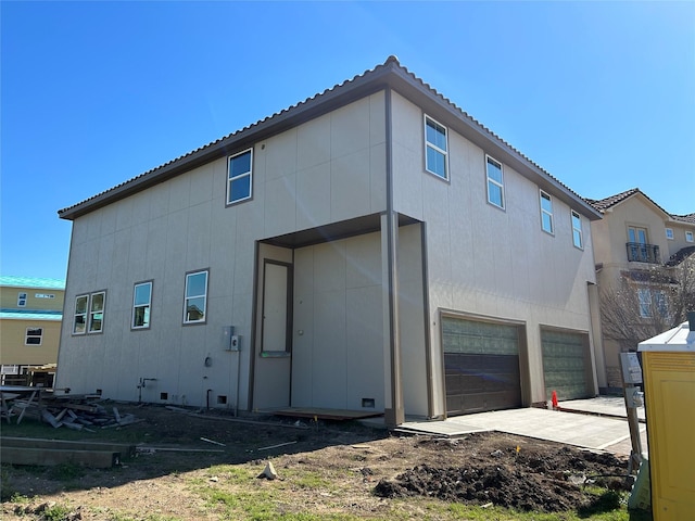 back of property with an attached garage