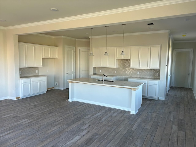 kitchen with white cabinets, an island with sink, dark wood-style flooring, and a sink