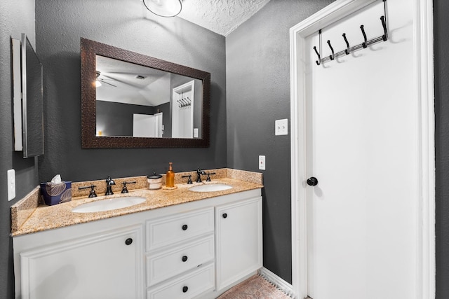 bathroom featuring vanity and a textured ceiling