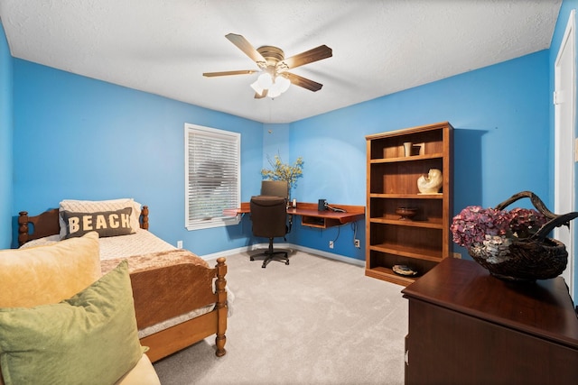 carpeted bedroom with a textured ceiling and ceiling fan