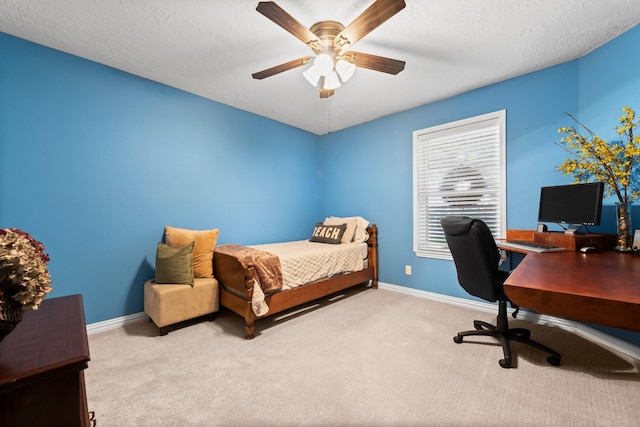 carpeted bedroom featuring a textured ceiling and ceiling fan