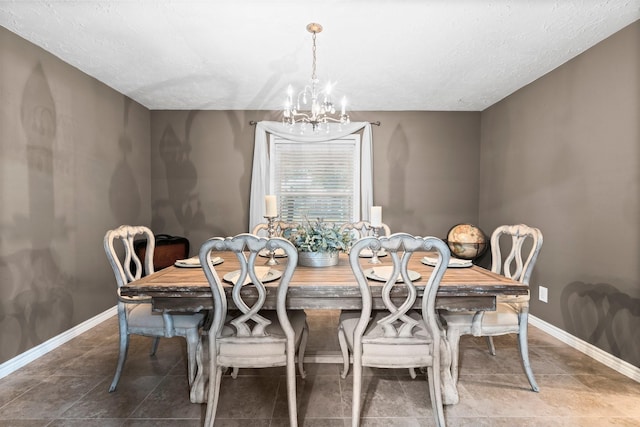 dining area featuring a textured ceiling and a chandelier