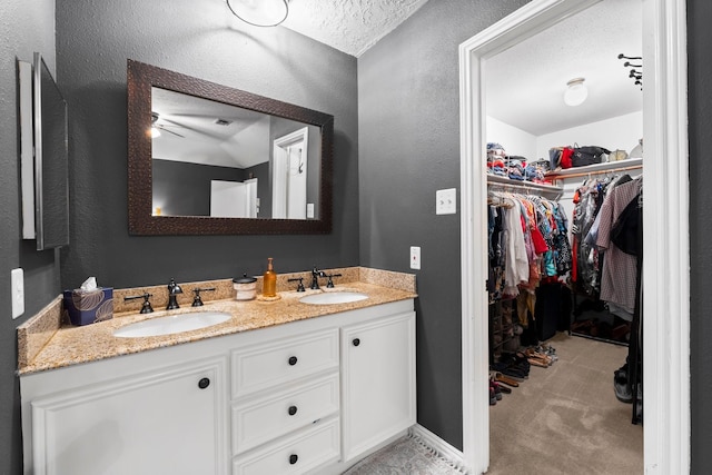 bathroom with vanity and a textured ceiling